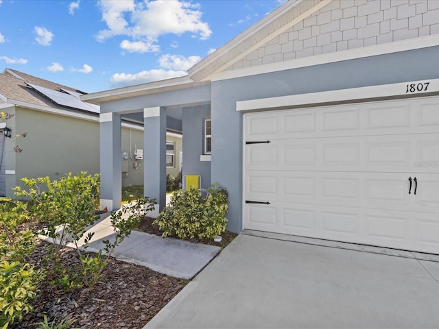 doorway to property with a garage