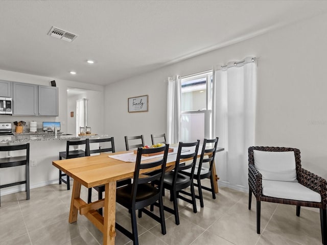 dining area with light tile patterned floors