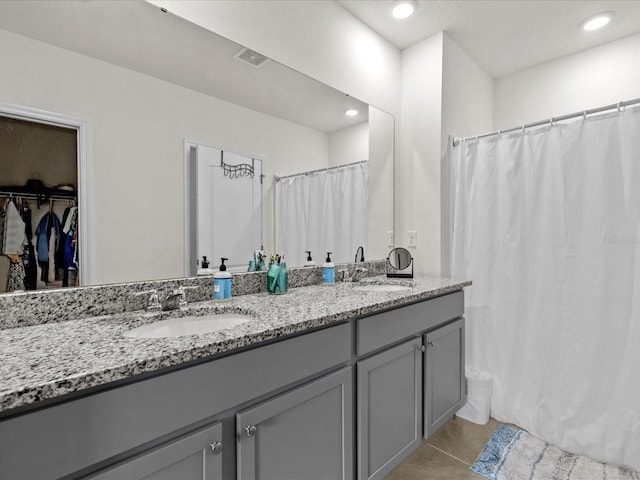 bathroom with tile patterned flooring and vanity