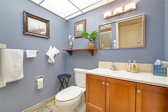 bathroom with tile patterned flooring, vanity, and toilet