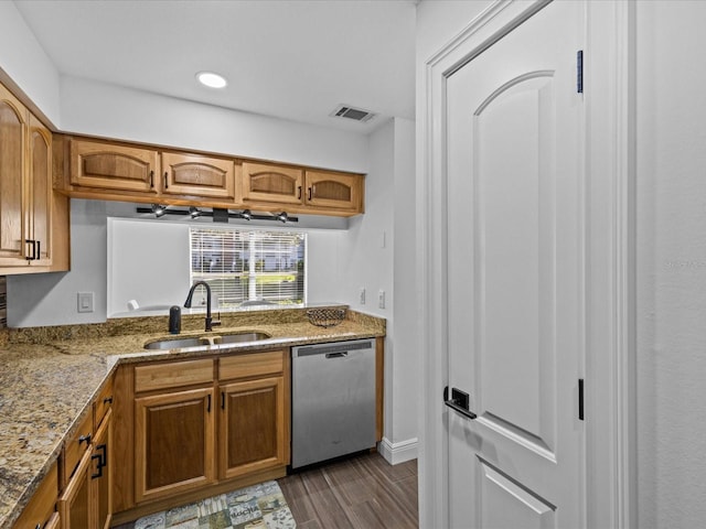 kitchen featuring light stone counters, sink, stainless steel dishwasher, and dark hardwood / wood-style floors