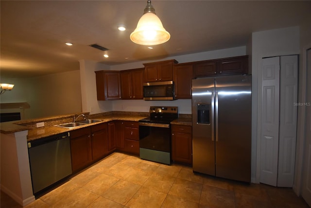 kitchen featuring pendant lighting, an inviting chandelier, sink, appliances with stainless steel finishes, and stone countertops