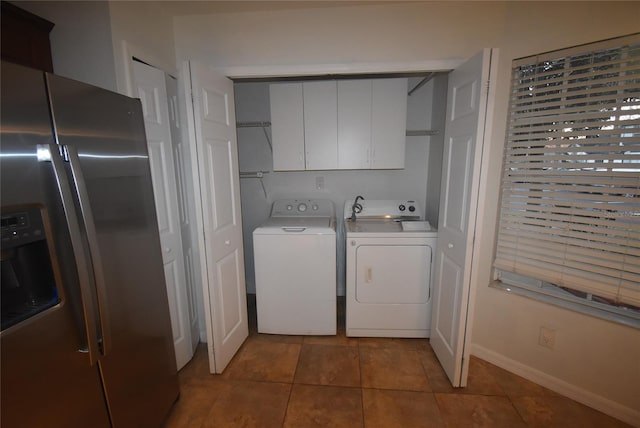 clothes washing area featuring separate washer and dryer and light tile patterned floors