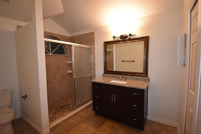 bathroom featuring vanity, a shower with shower door, lofted ceiling, and toilet