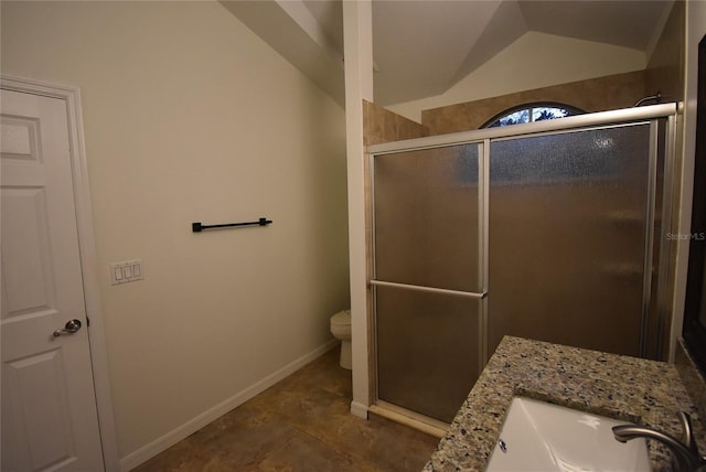 bathroom with vanity, toilet, a shower with door, and lofted ceiling