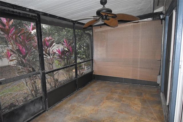 unfurnished sunroom featuring ceiling fan