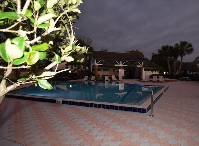 view of swimming pool with a patio area