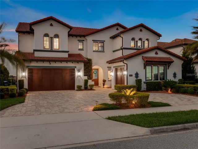 mediterranean / spanish house featuring a garage