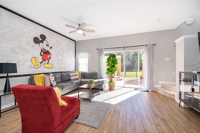 living room with light wood-type flooring and ceiling fan