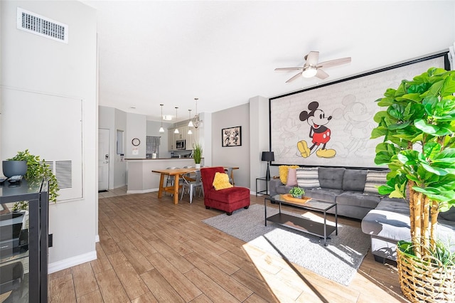 living room featuring light hardwood / wood-style floors and ceiling fan