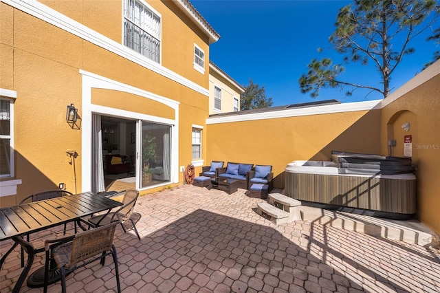 view of patio / terrace with a hot tub