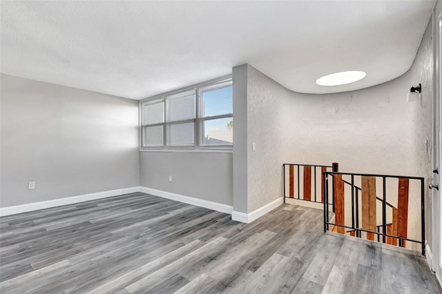 unfurnished room with wood-type flooring