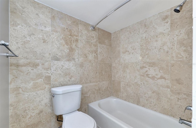 bathroom featuring toilet and tiled shower / bath