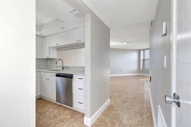 kitchen with dishwasher, sink, light tile patterned floors, tasteful backsplash, and white cabinetry