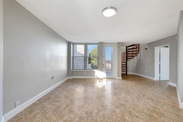 unfurnished living room with a textured ceiling