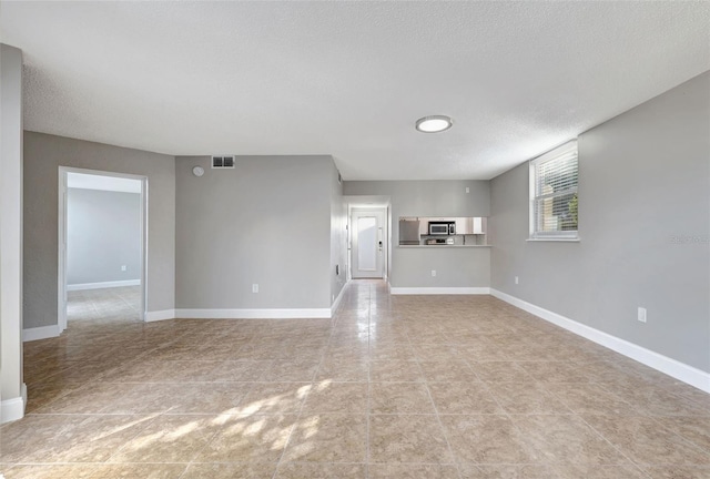 unfurnished living room featuring a textured ceiling