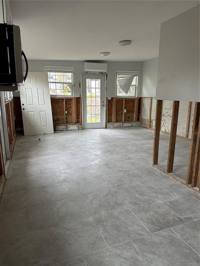 unfurnished living room with a wall mounted AC