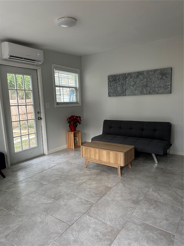 living room featuring a wealth of natural light and a wall unit AC