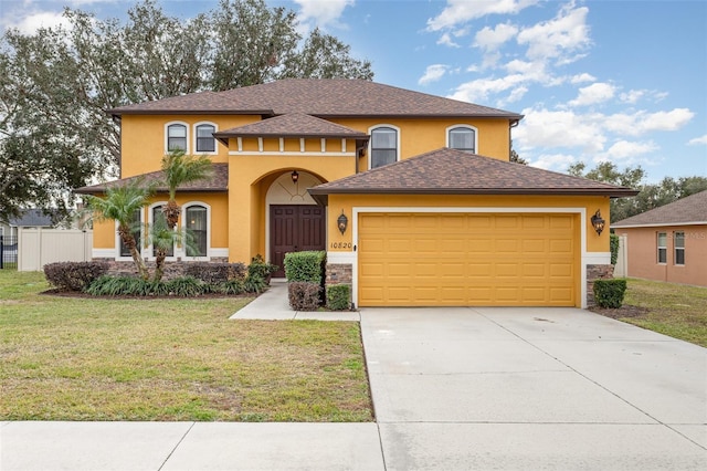 view of front facade with a garage and a front lawn