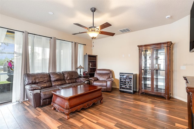 living room featuring ceiling fan, a wealth of natural light, dark hardwood / wood-style floors, and wine cooler