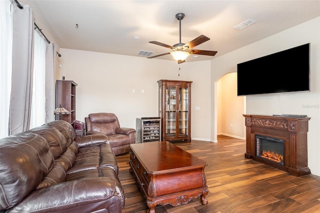 living room featuring dark wood-type flooring, wine cooler, and ceiling fan