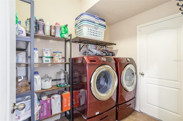 clothes washing area featuring light tile patterned floors and independent washer and dryer