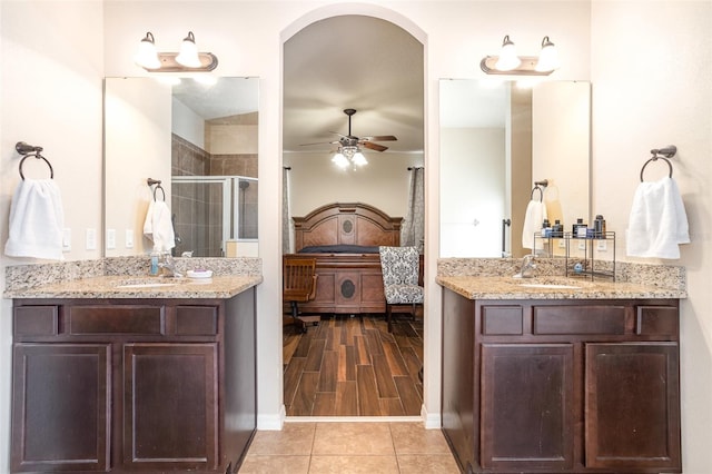 bathroom featuring walk in shower, ceiling fan, tile patterned floors, and vanity