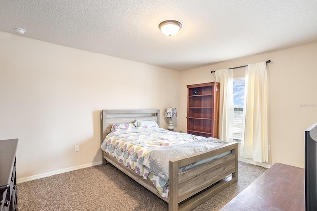 bedroom featuring a textured ceiling and carpet flooring