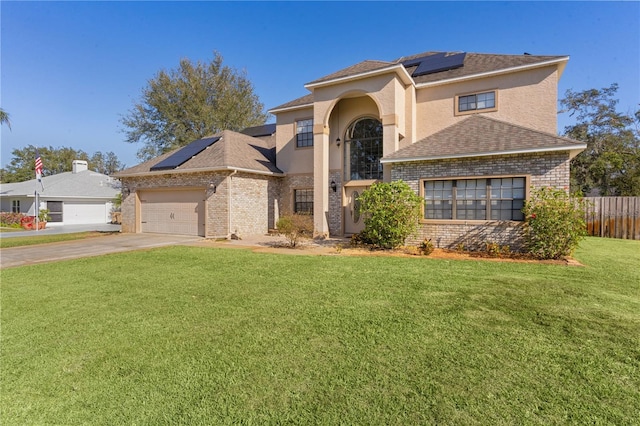 view of front facade featuring a garage, a front yard, and solar panels