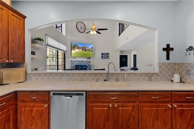 kitchen with tasteful backsplash, stainless steel dishwasher, ceiling fan, and sink