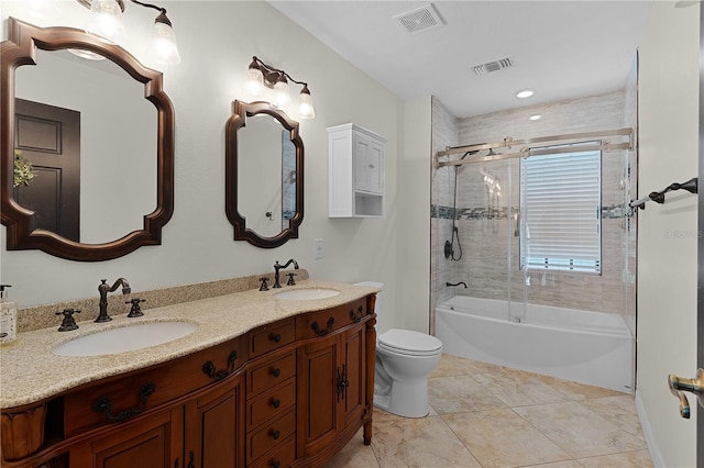 full bathroom featuring shower / bath combination with glass door, tile patterned floors, vanity, and toilet