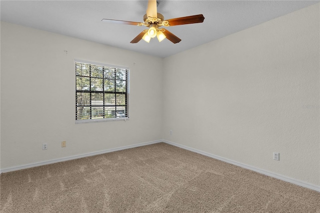 carpeted spare room featuring ceiling fan