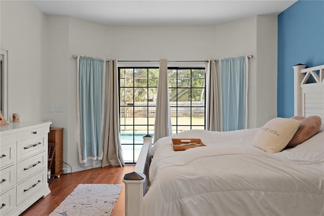 bedroom with access to exterior and light hardwood / wood-style flooring