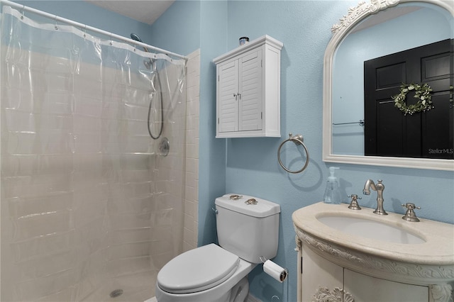 bathroom with vanity, curtained shower, and toilet