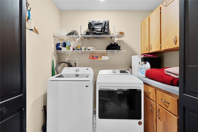 laundry area with cabinets and independent washer and dryer