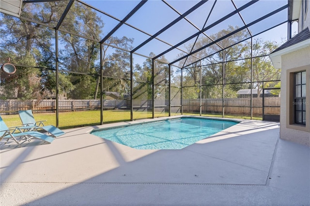 view of pool featuring glass enclosure, a yard, and a patio