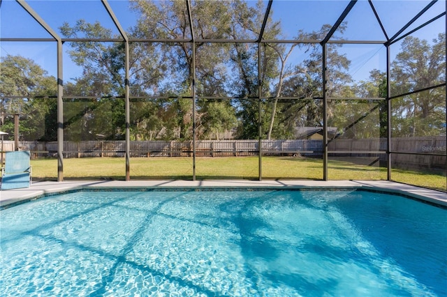 view of swimming pool with a lanai and a yard