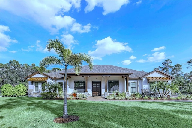 view of front facade featuring a front lawn and stucco siding