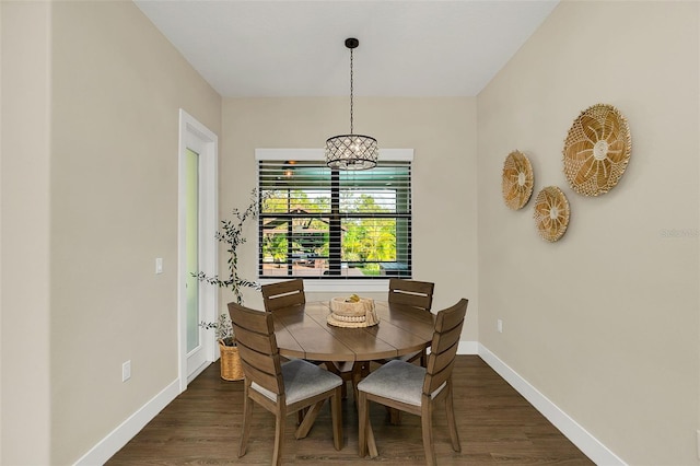 dining area featuring baseboards and dark wood-style flooring