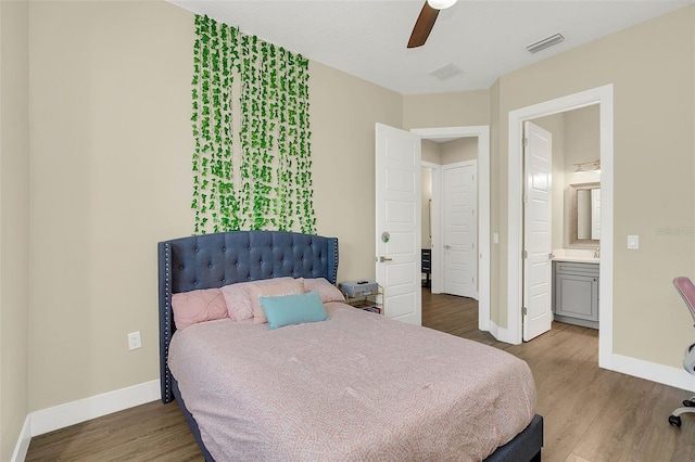 bedroom featuring ceiling fan, hardwood / wood-style floors, and ensuite bathroom