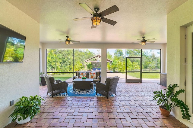 sunroom / solarium with a wealth of natural light and ceiling fan