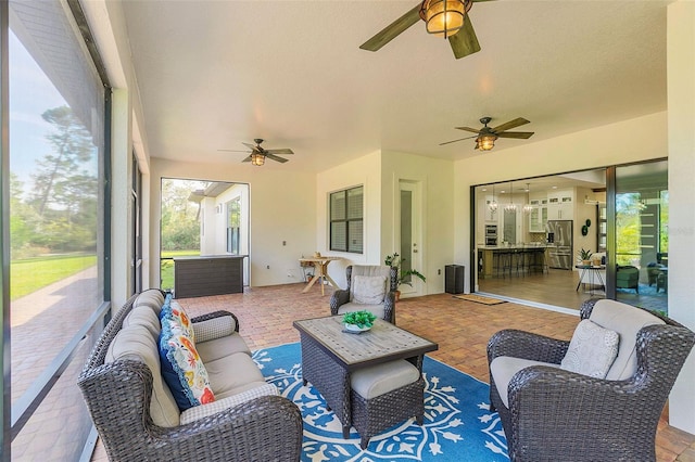 sunroom with a ceiling fan