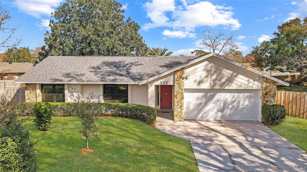 single story home with a front yard and a garage