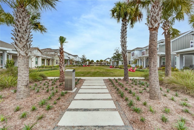 view of property's community featuring a yard