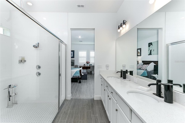 bathroom with vanity and a shower with shower door