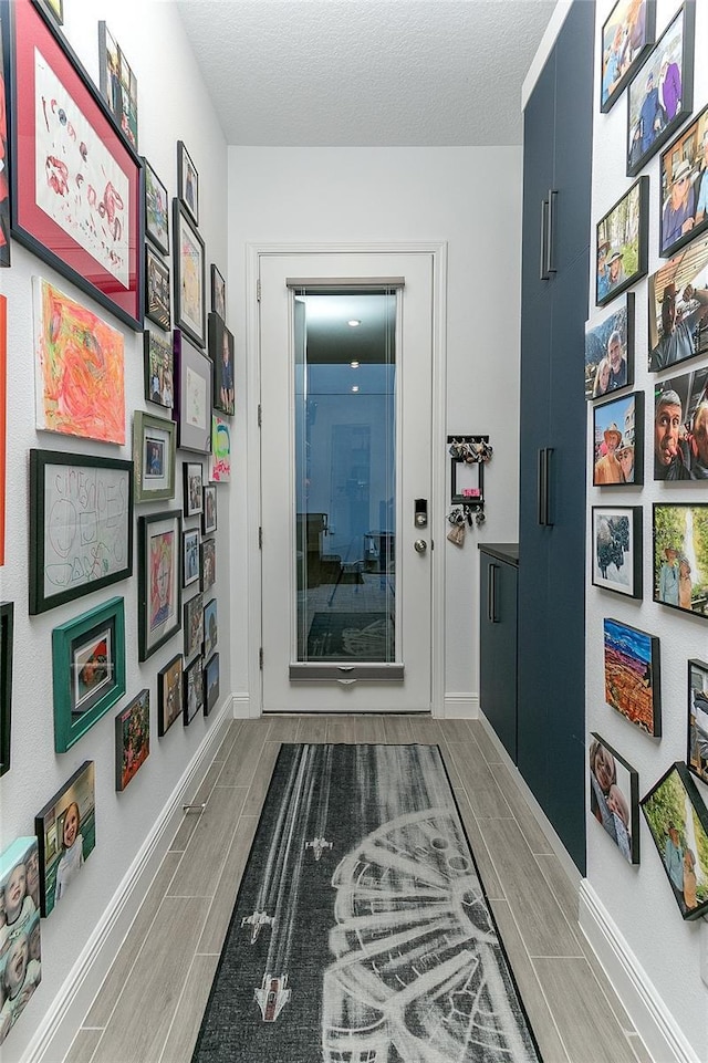 hallway featuring a textured ceiling