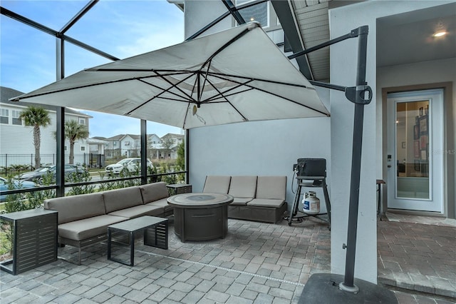 view of patio with glass enclosure and an outdoor living space