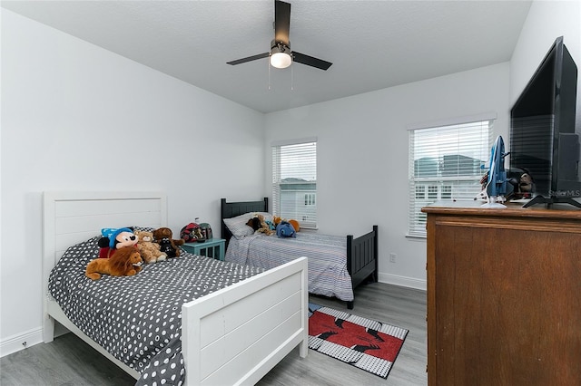 bedroom featuring ceiling fan and dark hardwood / wood-style floors