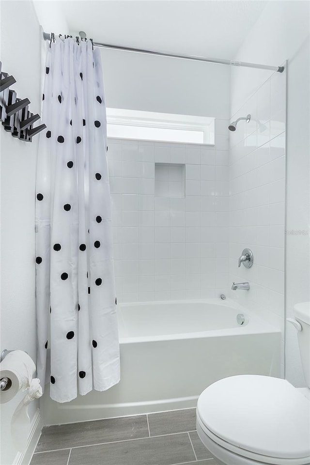 bathroom with shower / bath combo and toilet