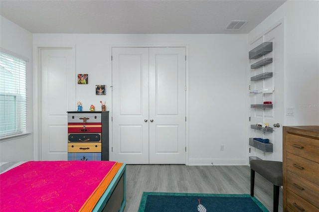 bedroom featuring light hardwood / wood-style flooring and a textured ceiling